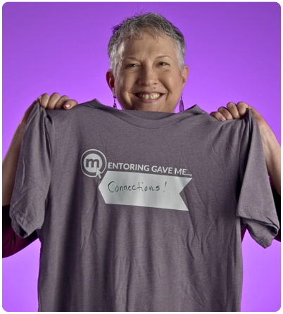 Case Study AMD 4 Lisa Graham holding a shirt that says: Mentoring gave me connections