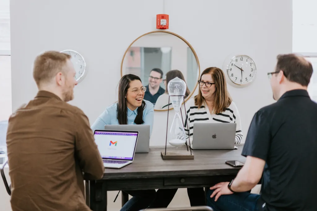 Why Having a Frontend Mentor Boosts Programming Careers 3 A group of working together within a frontend mentor program to upsill at a table.
